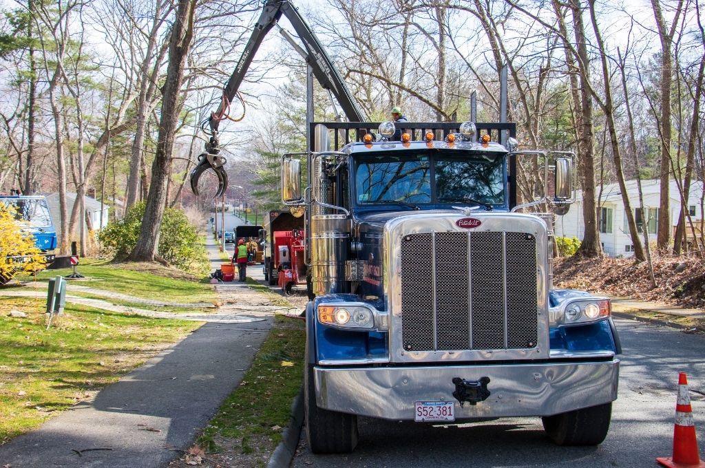 American Climbers vehicles and equipment parked on a residential street in Massachusetts. 