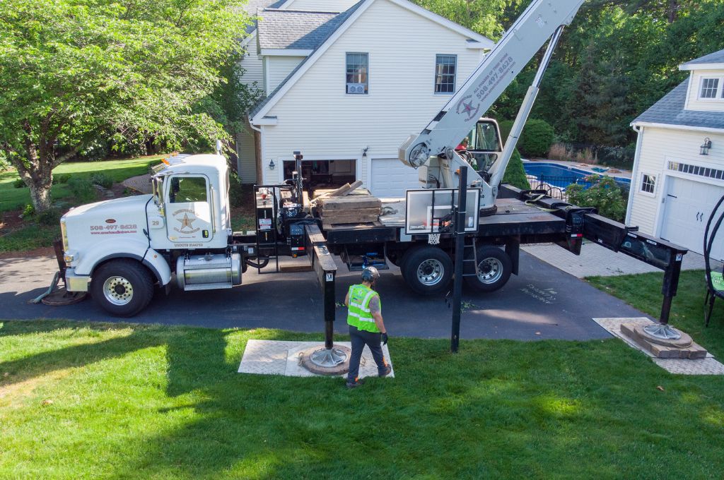 The American Climbers tree crane preparing for a tree removal on a Massachusetts residential property.