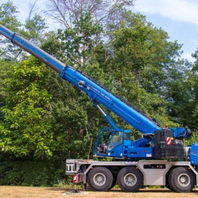 An American Climbers blue tree crane with the boom (arm) extended.